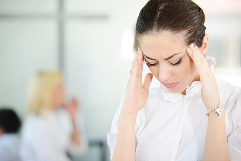 Business woman with stress and worries in office